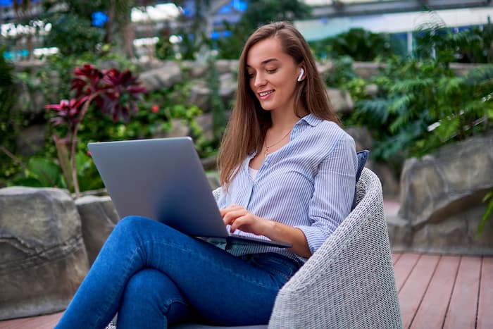 Girl Studing In Garden On A Laptop