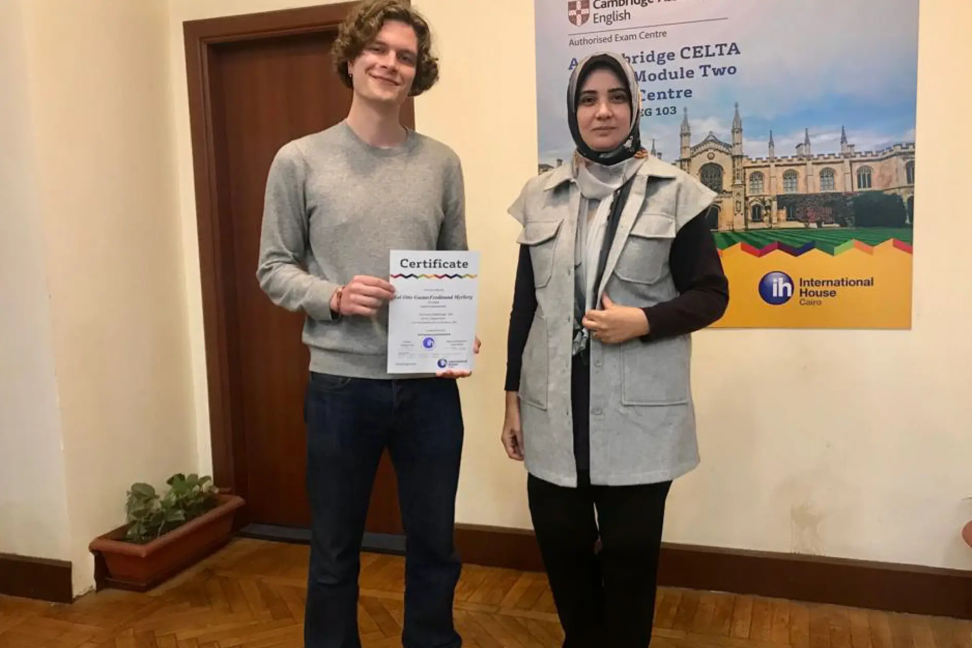 Arabic Course Student Holding His Certificate Proudly And Taking A Photo With His Teacher
