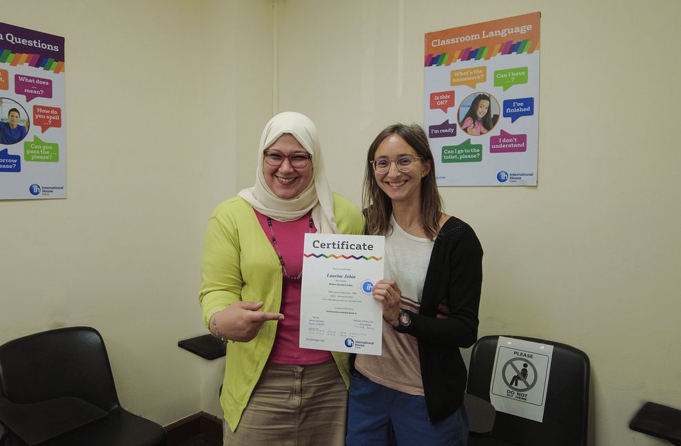 Arabic Course Grad Taking A Photo Proudly With Her Teacher